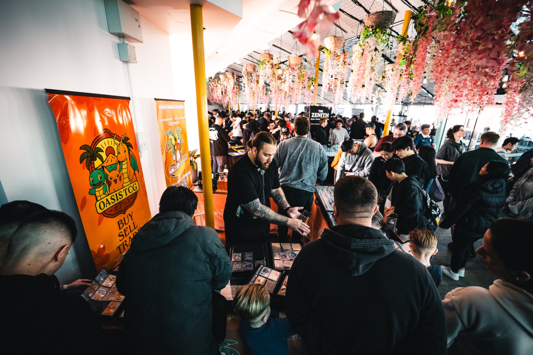 Oasis TCG booth surrounded by collectors